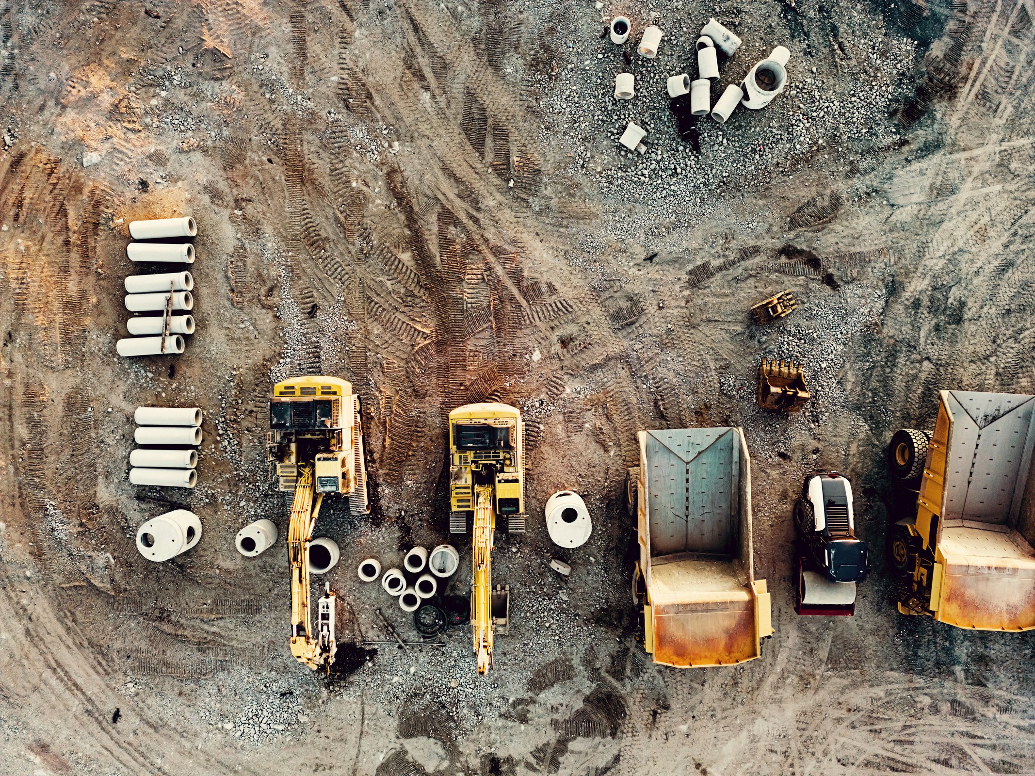 an aerial view of construction equipment on a dirt lot